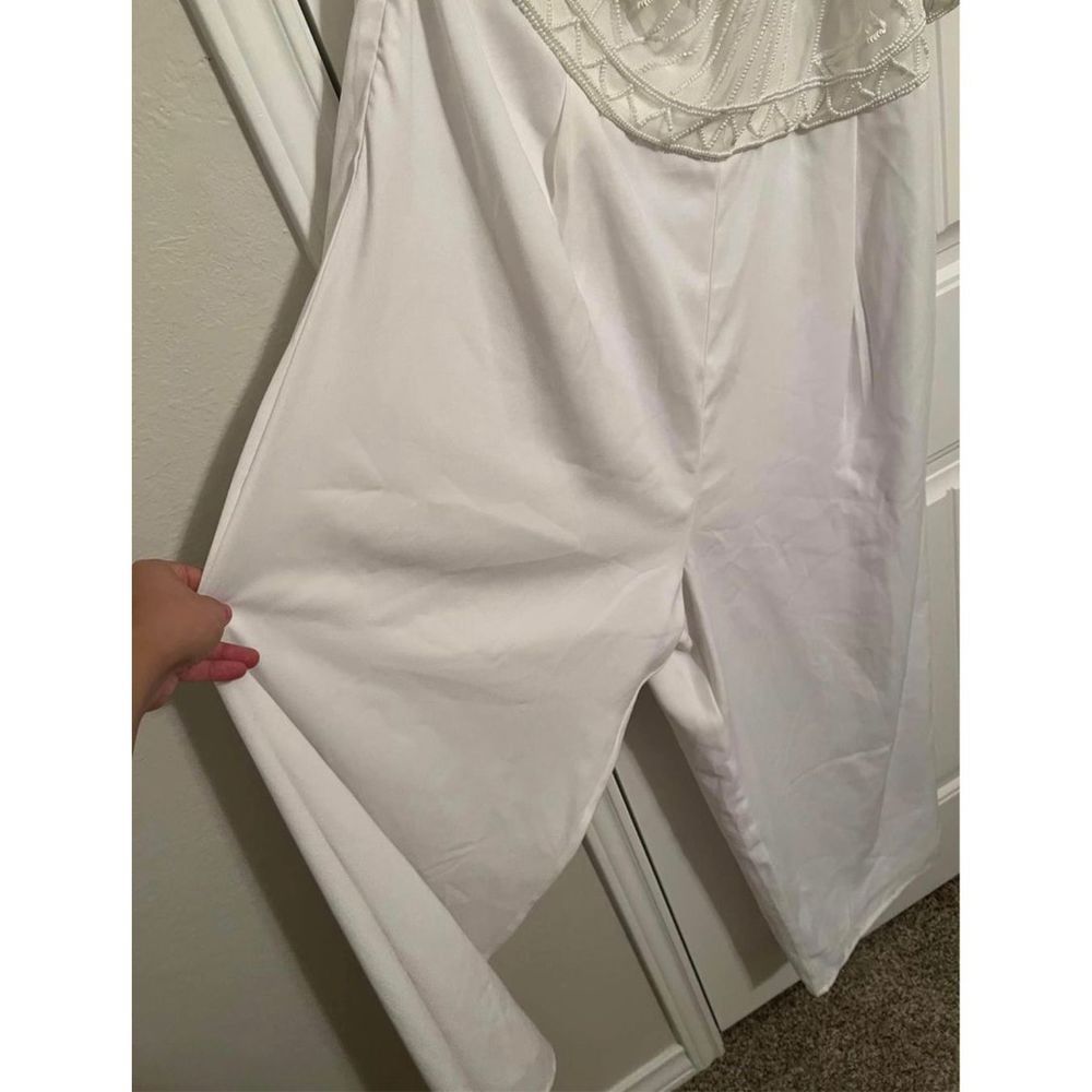 One shoulder white jumpsuit from Eloquii.
Size 18
Beaded detail on top.
Purchase - Picture 6 of 11